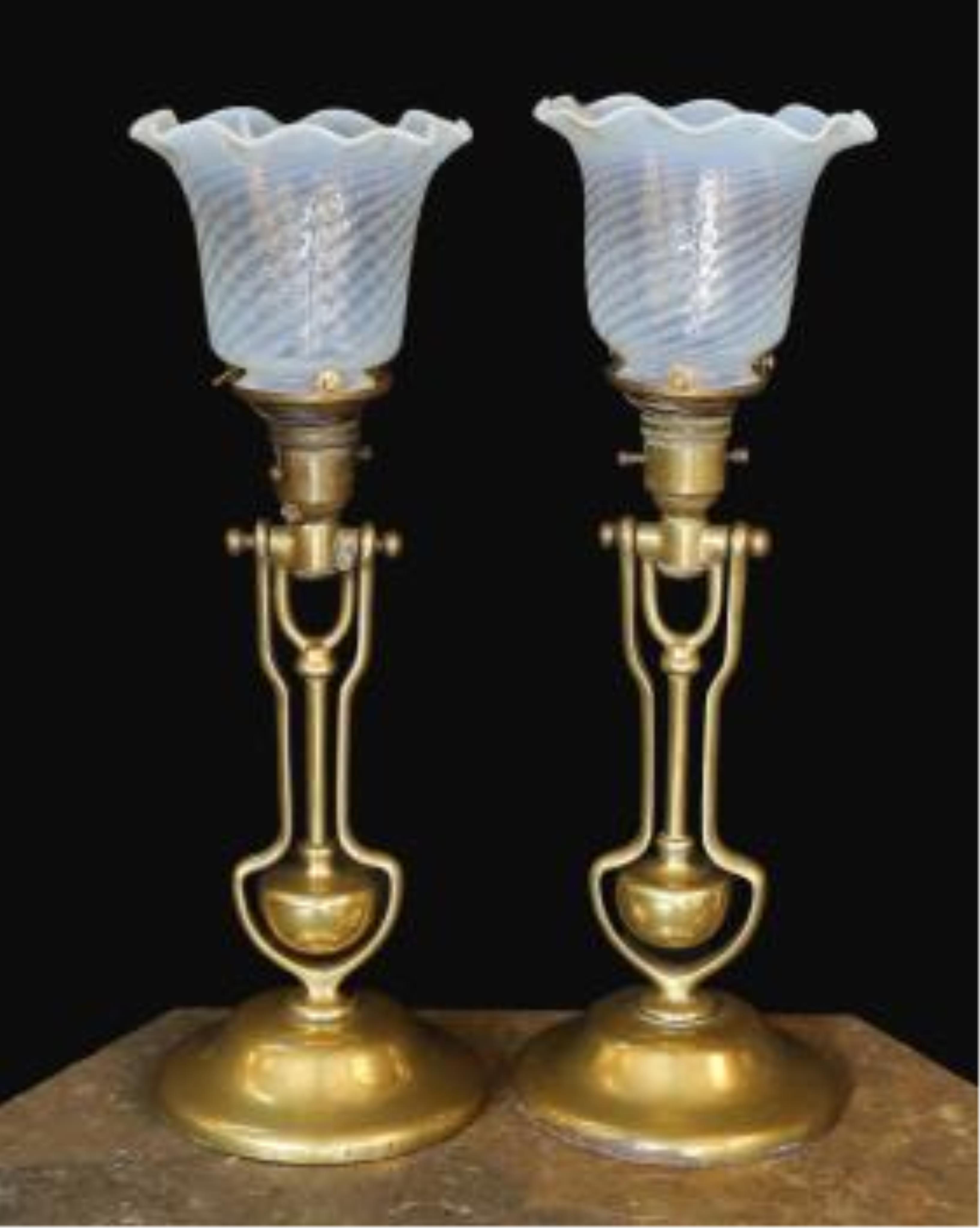 A pair of brass Pullman lamps with gimbal stems and Vaseline glass shades, modelled for wall mounting or freestanding, height to top of shade 40cm. Condition - good